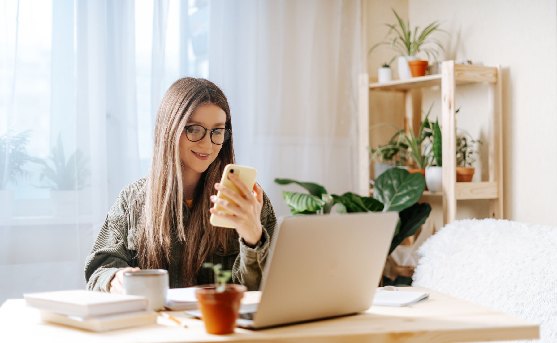 Woman with laptop and phone